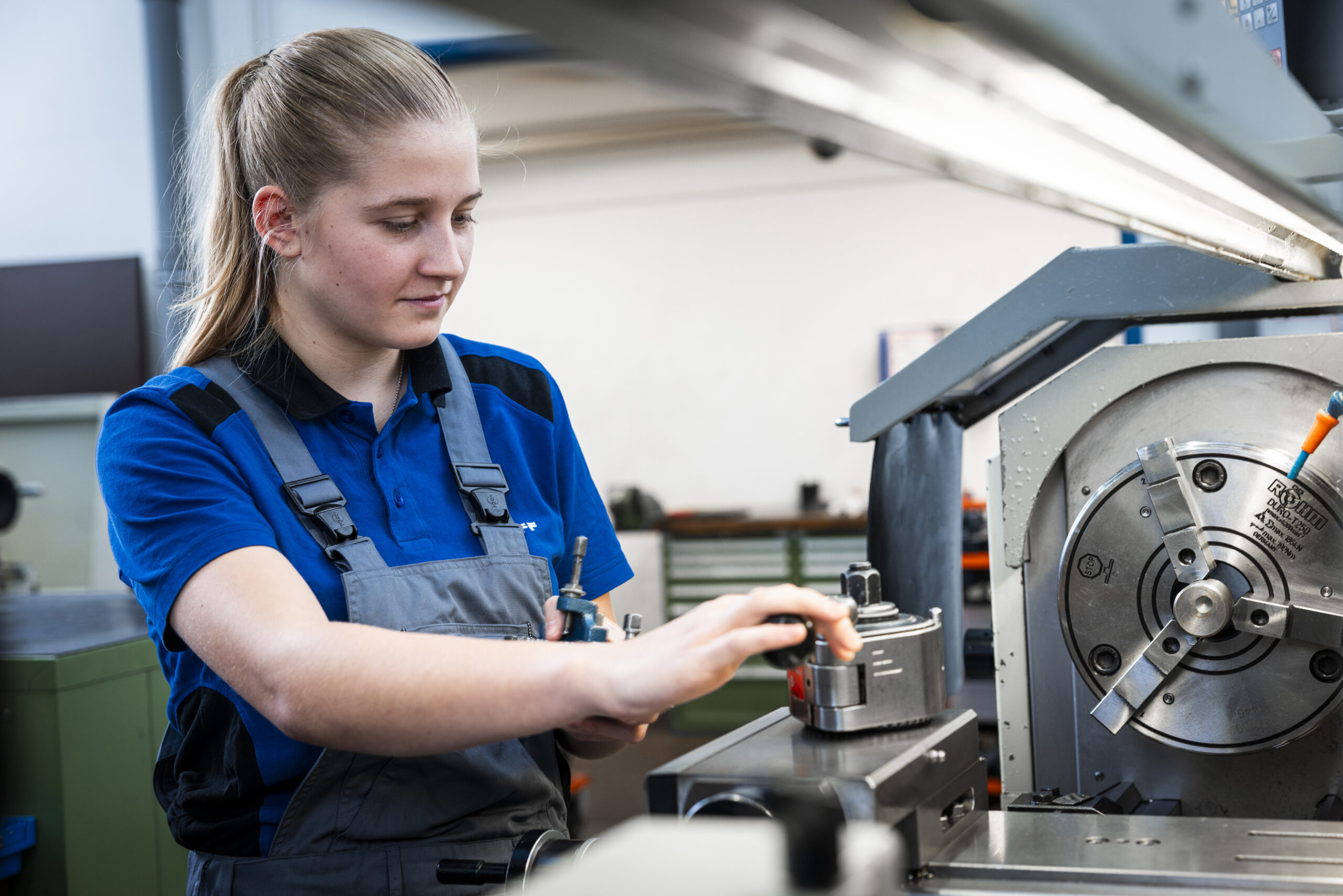 Apprentice working at a lathe