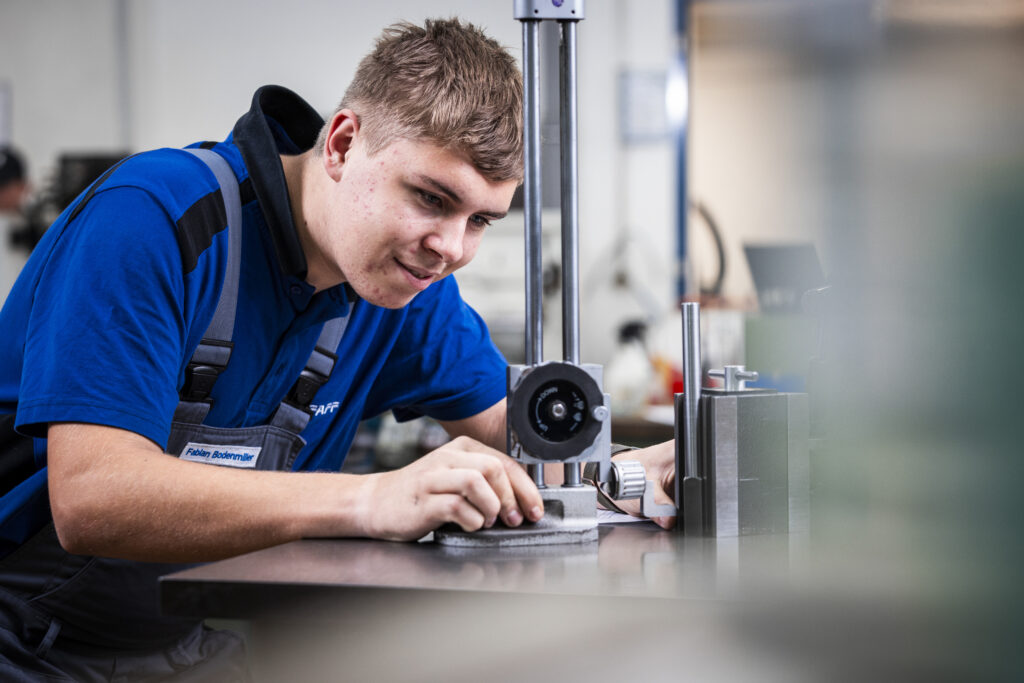 Apprentice works concentrated on a measuring device