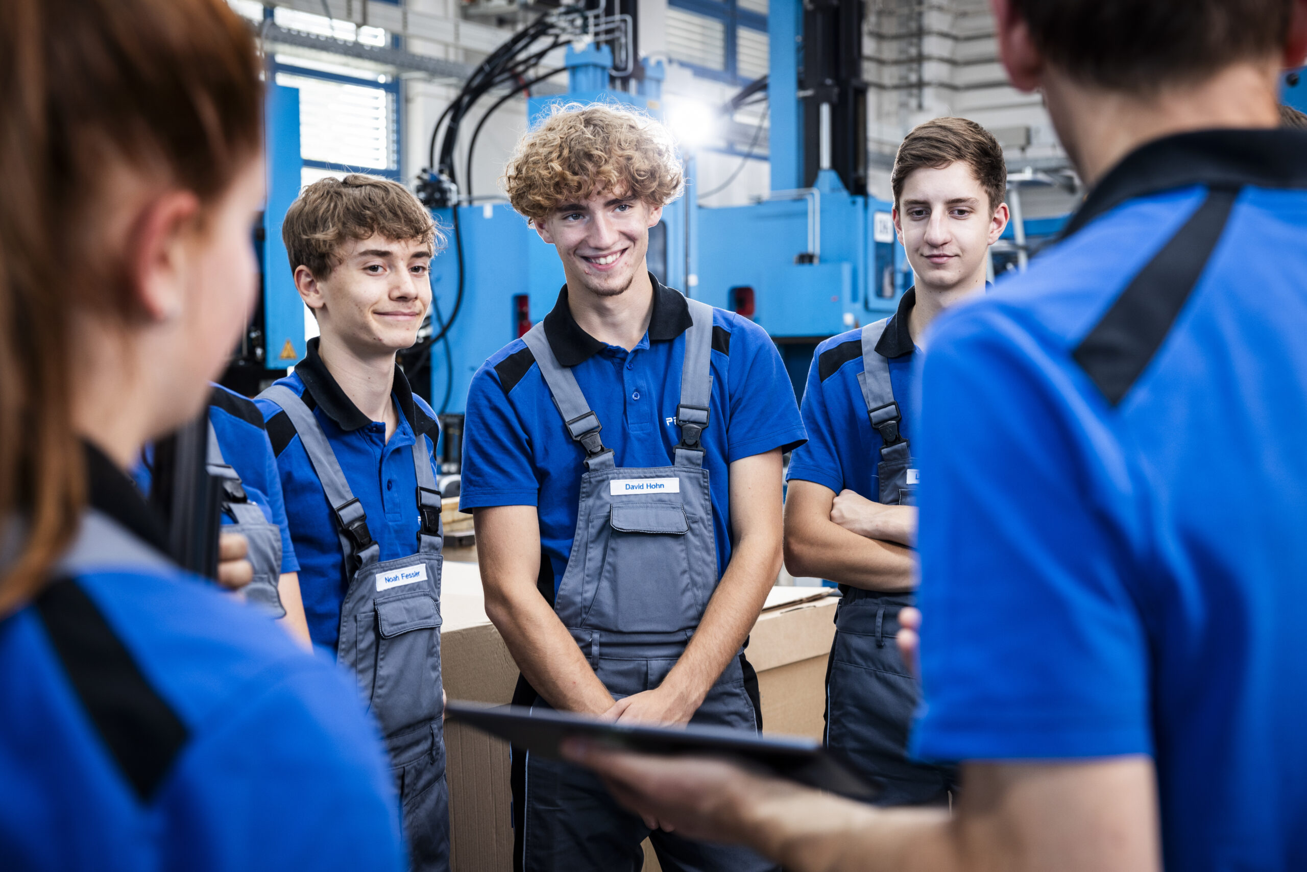Group of apprentices in conversation with an instructor