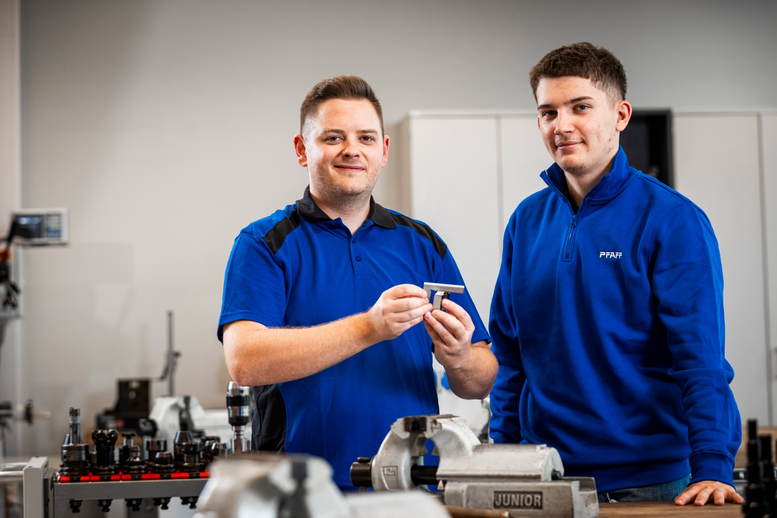 Trainer and apprentice working on a workpiece